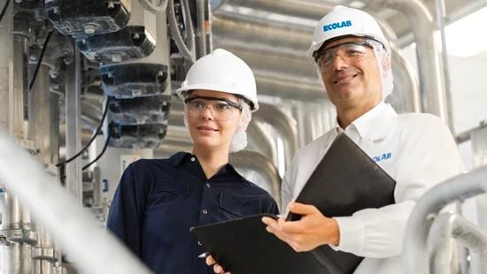 Two Ecolab technicians at a manufacturing facility